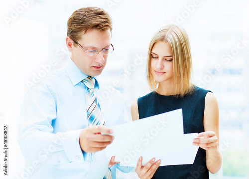 Photo: Two young business collegues. Two young business collegues.