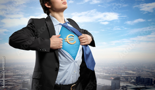 Photo: Businessman showing superman suit underneath shirt Businessman showing superman suit underneath shirt