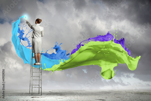 Photo: Young woman drawing splashes Young woman drawing splashes