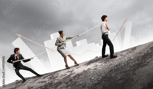 Photo: Three business people pulling rope Three business people pulling rope