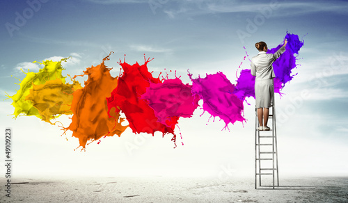 Photo: Young woman drawing splashes Young woman drawing splashes