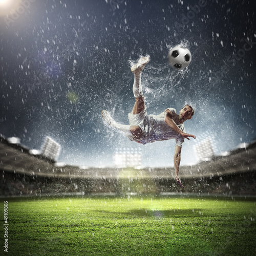 Photo: football player striking the ball football player striking the ball