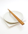 White empty plate with chopsticks
