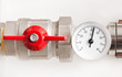 Photo: Water thermometer with red valve and metal pipes Water thermometer with red valve and metal pipes