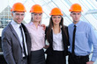 People in helmets on a construction site