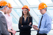 People in helmets on a construction site