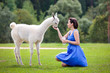 Photo: Young attractive woman feeding baby lama Young attractive woman feeding baby lama