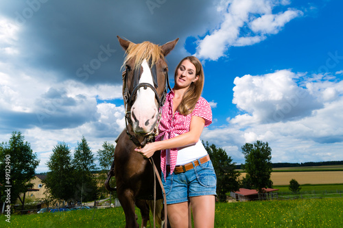 Photo: Young woman on the meadow with horse Young woman on the meadow with horse