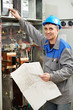 Happy electrician working at power line box