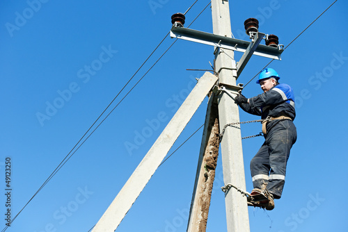 Photo: power electrician lineman at work on pole power electrician lineman at work on pole