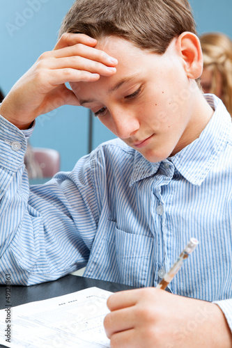 Photo: School Boy Concentrates on Standardized Test School Boy Concentrates on Standardized Test