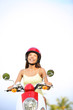 Photo: Woman on scooter thinking looking Woman on scooter thinking looking