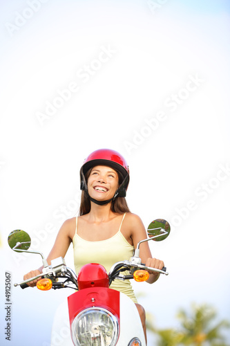 Photo: Woman on scooter thinking looking Woman on scooter thinking looking