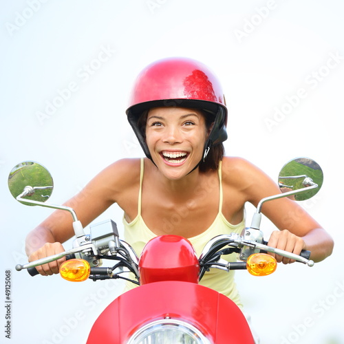 Photo: Excited woman on scooter happy Excited woman on scooter happy