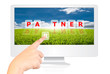 Hand pushing Partner word on monitor screen.