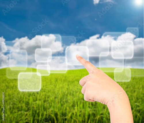 Photo: Business lady hand pushing button on the blue sky field. Business lady hand pushing button on the blue sky field.