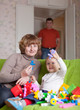 Happy mother and child plays with toys