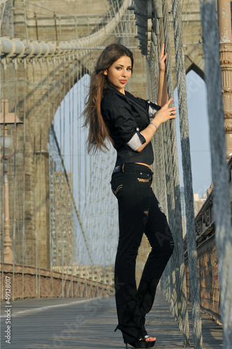 Photo: Fashion model posing pretty on Brooklyn Bridge in New York Fashion model posing pretty on Brooklyn Bridge in New York