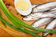 salted anchovies, egg, and spring onion on wooden