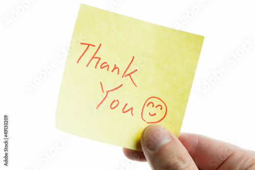 Photo: hand showing a post-it to thank you hand showing a post-it to thank you