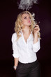 Photo: Sexy Woman with Cigar Exhaling Smoke on Dark Background Sexy Woman with Cigar Exhaling Smoke on Dark Background