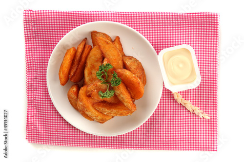 Photo: Appetizing village potatoes on plate isolated on white Appetizing village potatoes on plate isolated on white