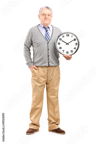 Photo: Full length portrait of a gentleman holding a wall clock Full length portrait of a gentleman holding a wall clock
