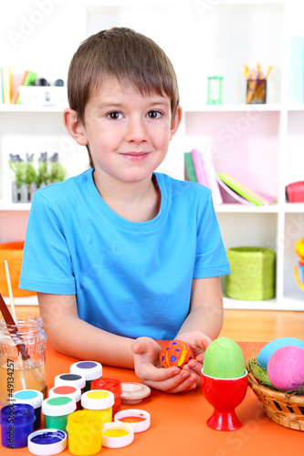 Photo: Child's hands holding painted easter egg Child's hands holding painted easter egg