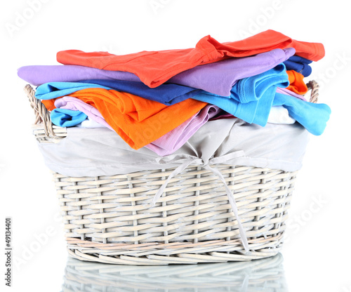 Photo: Clothes in wooden basket isolated on white Clothes in wooden basket isolated on white