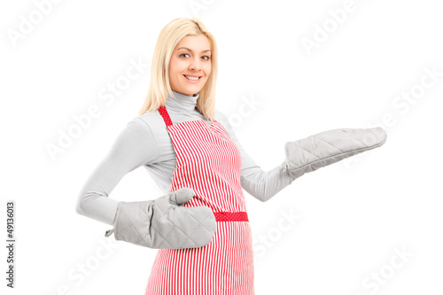 Photo: Young houswife wearing cooking mittens and apron Young houswife wearing cooking mittens and apron