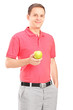 Photo: Young man posing with an apple in his hand Young man posing with an apple in his hand