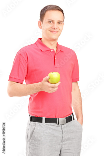 Photo: Young man posing with an apple in his hand Young man posing with an apple in his hand