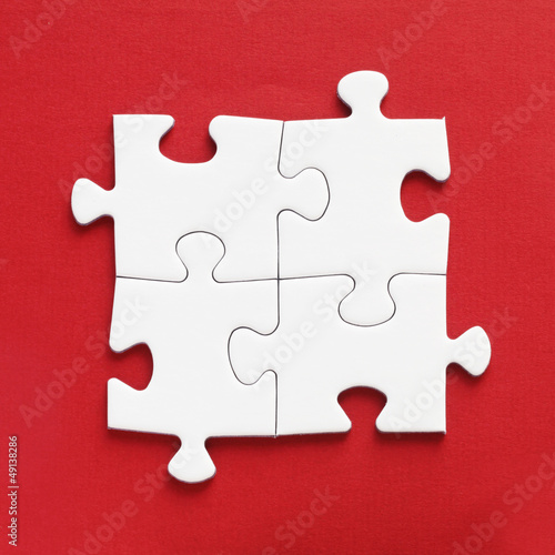 Photo: Jig Saw Puzzle - Four White Pieces on Red Jig Saw Puzzle - Four White Pieces on Red