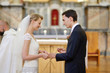 Bride and groom holding wedding rings