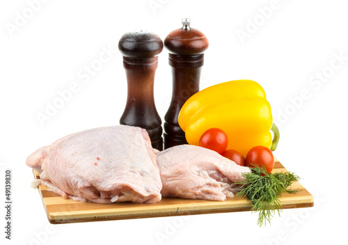 Photo: Fresh raw chicken wings on chopping board with roma tomatoes Fresh raw chicken wings on chopping board with roma tomatoes
