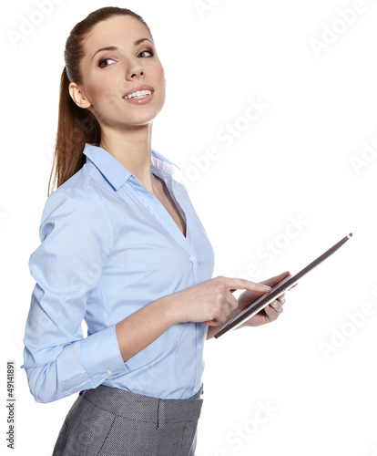 Photo: young attractive business woman uses a mobile tablet computer wi young attractive business woman uses a mobile tablet computer wi
