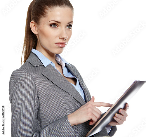 Photo: Businesswoman standing in hall with electronic pad Businesswoman standing in hall with electronic pad