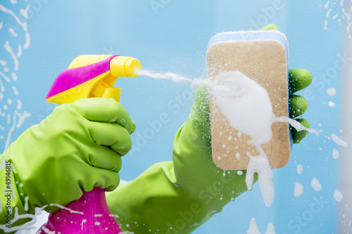 Photo: Cleaning - cleaning window pane with spray detergent Cleaning - cleaning window pane with spray detergent