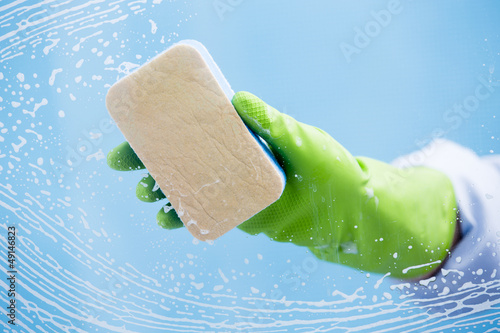Photo: Cleaning - cleaning window pane with spray detergent Cleaning - cleaning window pane with spray detergent