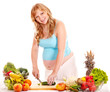 Photo: Pregnant woman preparing food . Pregnant woman preparing food .