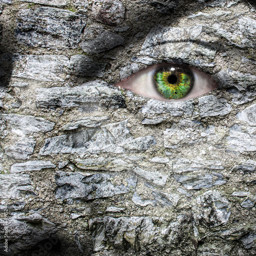 Photo: Stone face with green eye Stone face with green eye