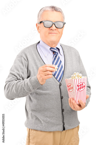Photo: Mature gentleman eating popcorn Mature gentleman eating popcorn