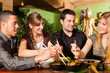 Foto: Young people eating in Thai restaurant Young people eating in Thai restaurant