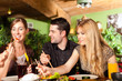 Foto: Young people eating in Thai restaurant Young people eating in Thai restaurant