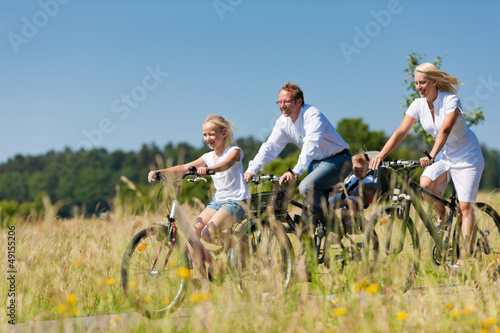 Photo: Family cycling outdoors in summer Family cycling outdoors in summer