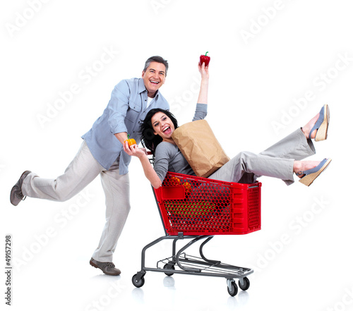 Photo: Happy couple with a grocery shopping cart. Happy couple with a grocery shopping cart.