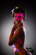 Pretty young woman in glowing flowers - uv light