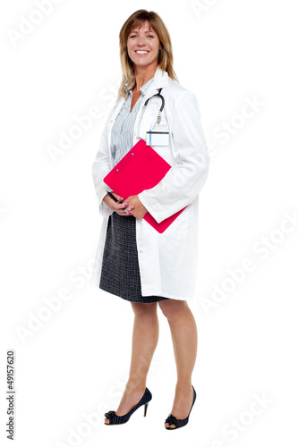 Photo: Smiling female physician holding clipboard Smiling female physician holding clipboard