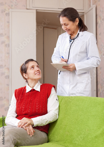 Photo: doctor asks female patient feels doctor asks female patient feels