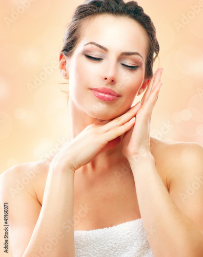 Photo: Spa Woman. Beautiful Girl After Bath Touching Her Face Spa Woman. Beautiful Girl After Bath Touching Her Face